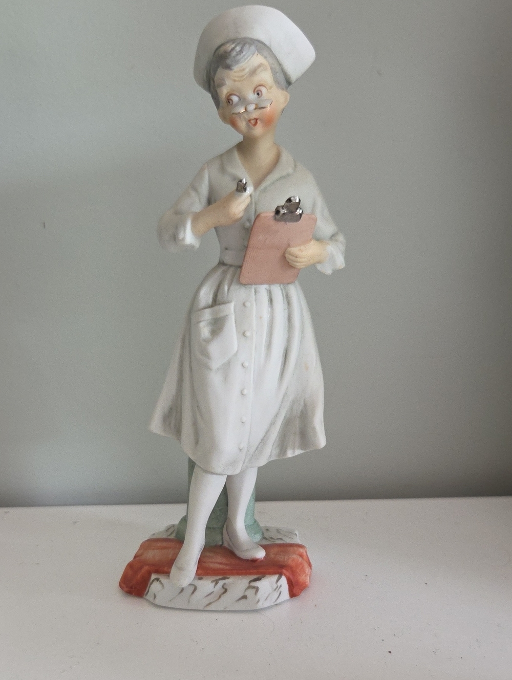 Vintage Andrea Sadek Porcelain Nurse Figurine in White with Pink Clipboard